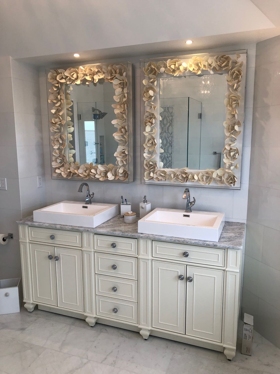 A bathroom with two sinks and two mirrors.