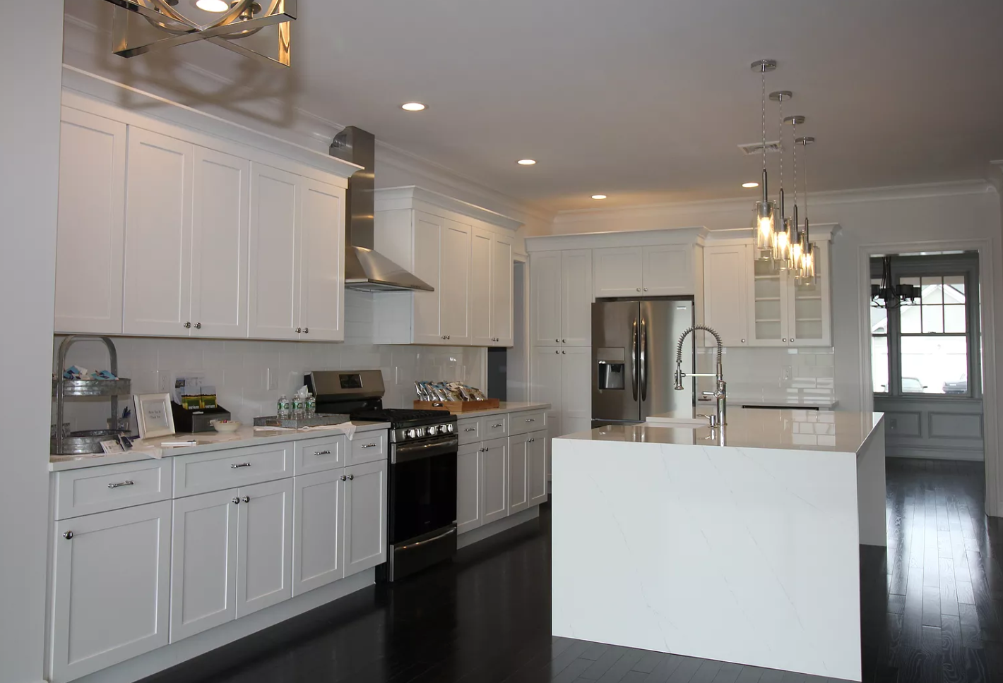 A kitchen with white cabinets and stainless steel appliances