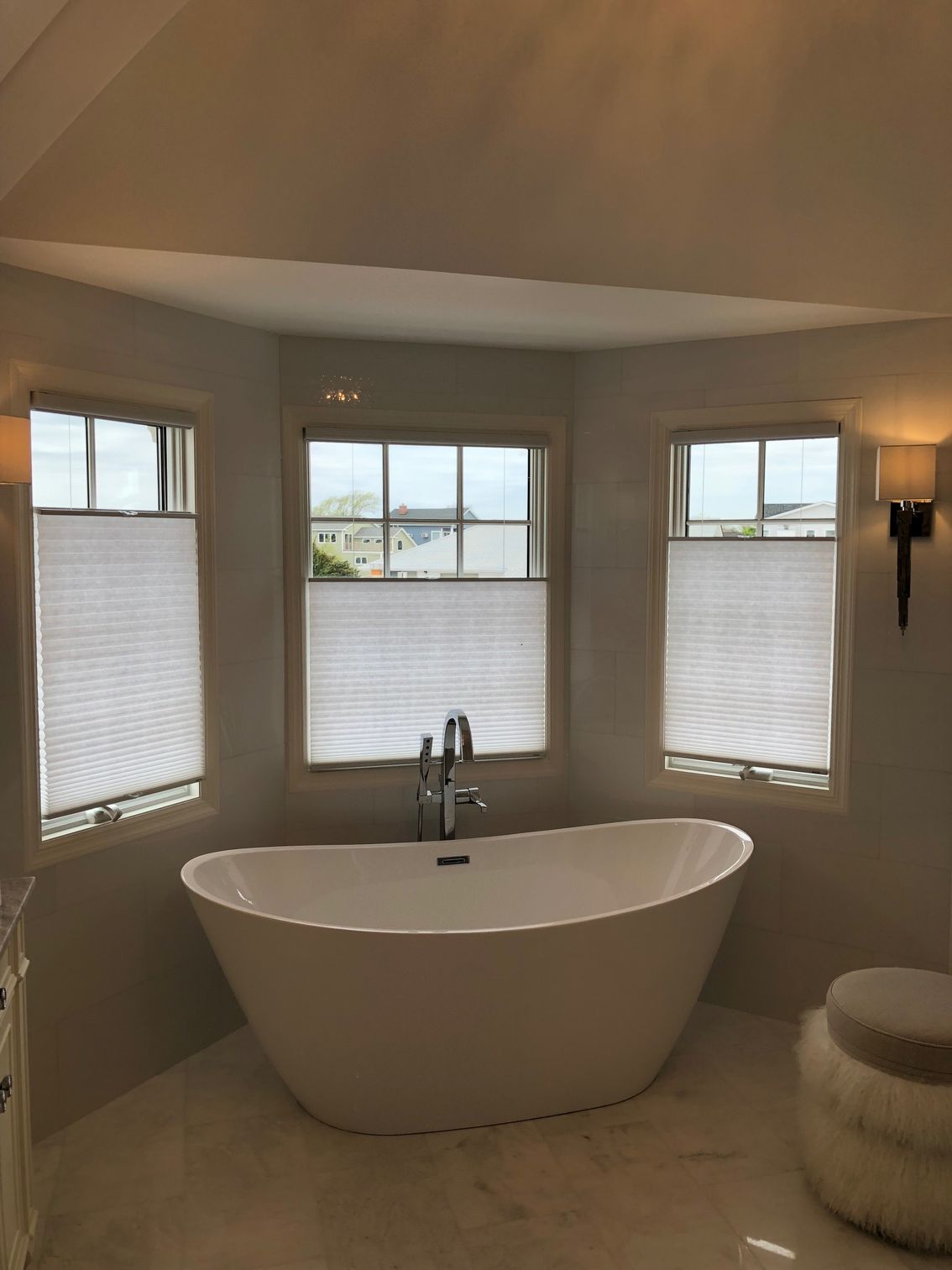 There is a bathtub in the middle of the bathroom.