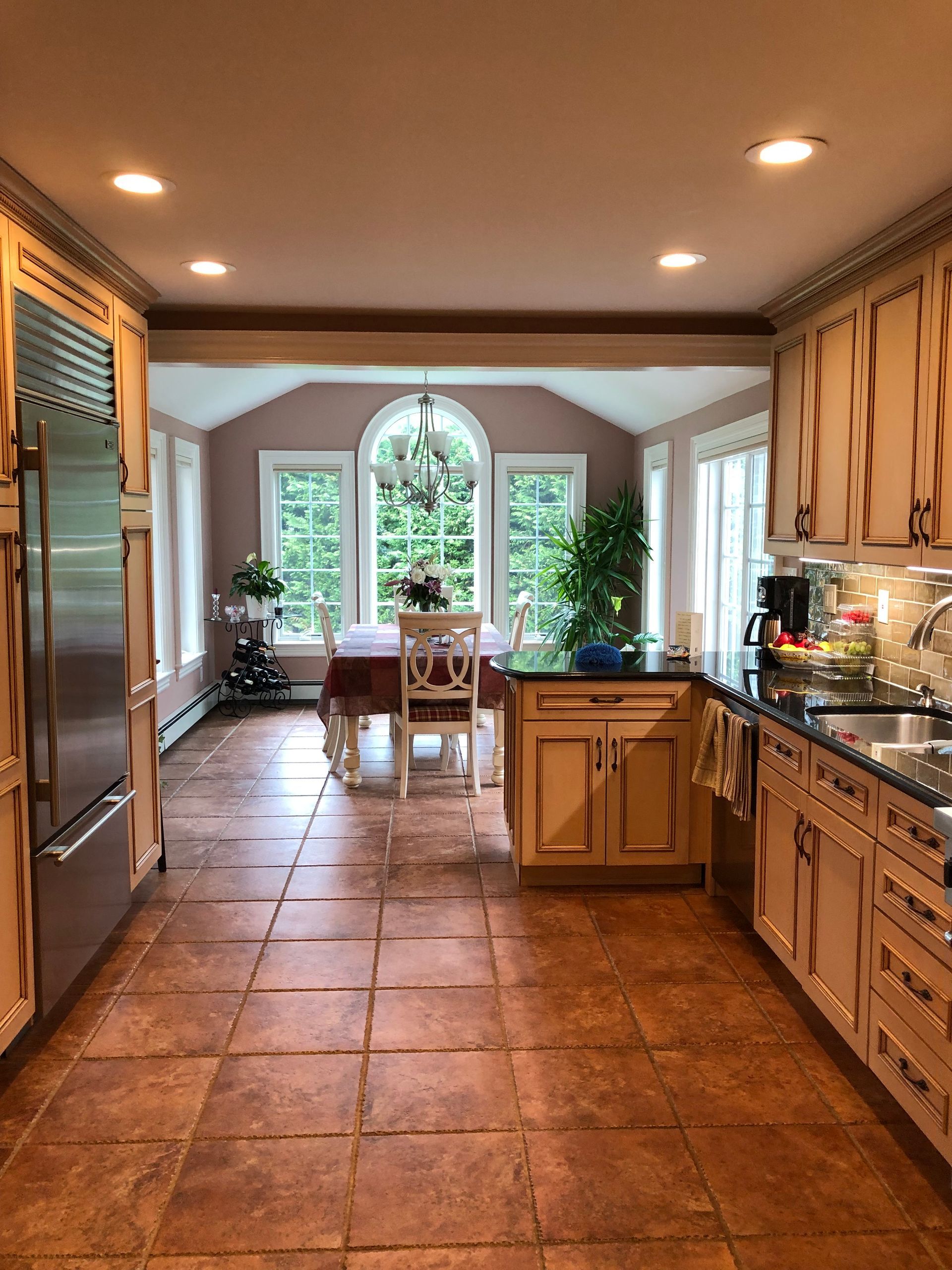 A kitchen with stainless steel appliances and wooden cabinets