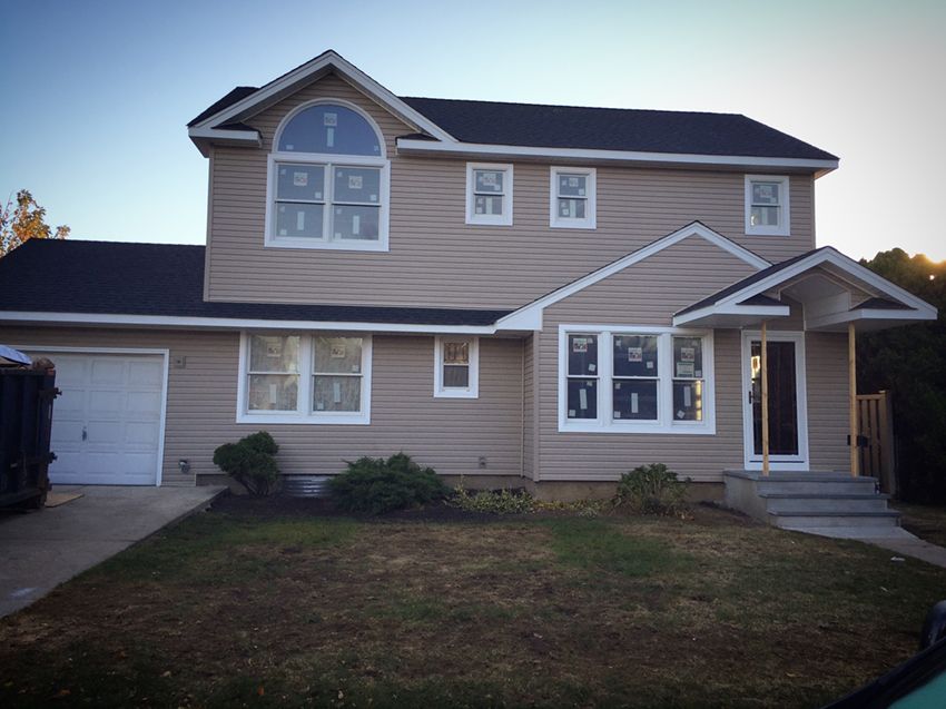 A house with a black roof and a lot of windows