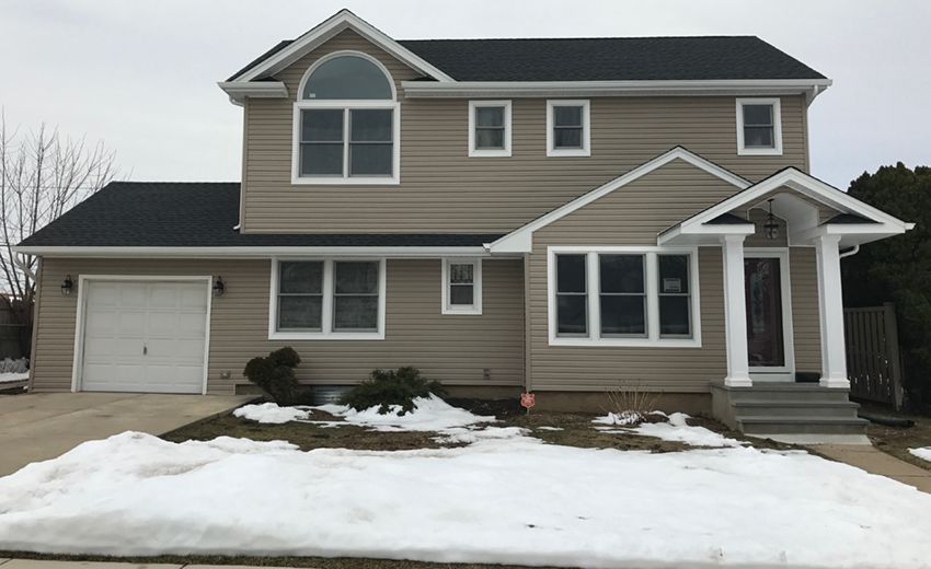 A large house with a garage and a lot of windows
