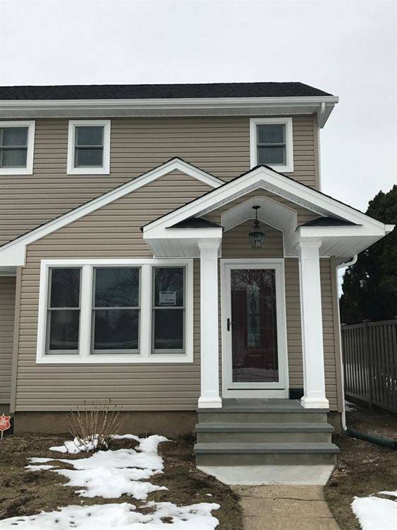 The front of a house with a porch and stairs
