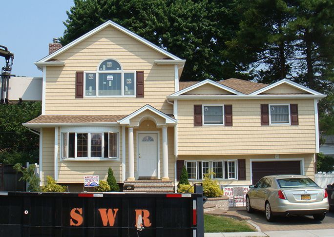 A large house with a car parked in front of it