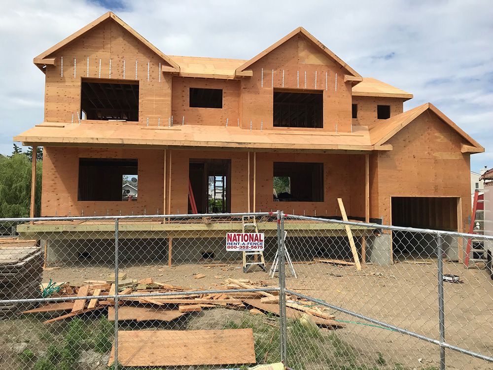 A house that is being built with a for sale sign in front of it
