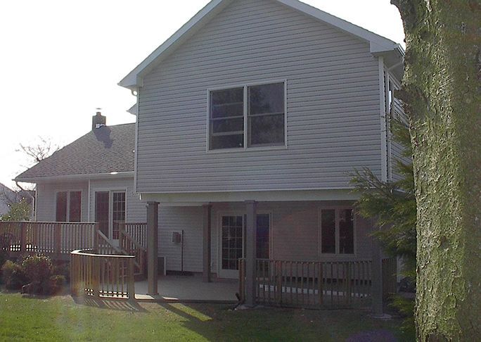 The back of a house with a deck and stairs