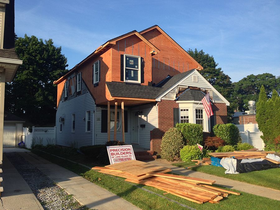 A house that is being remodeled with a sign in front of it