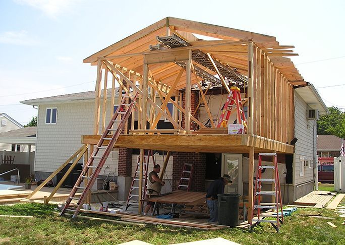 A house is being built with a deck and stairs