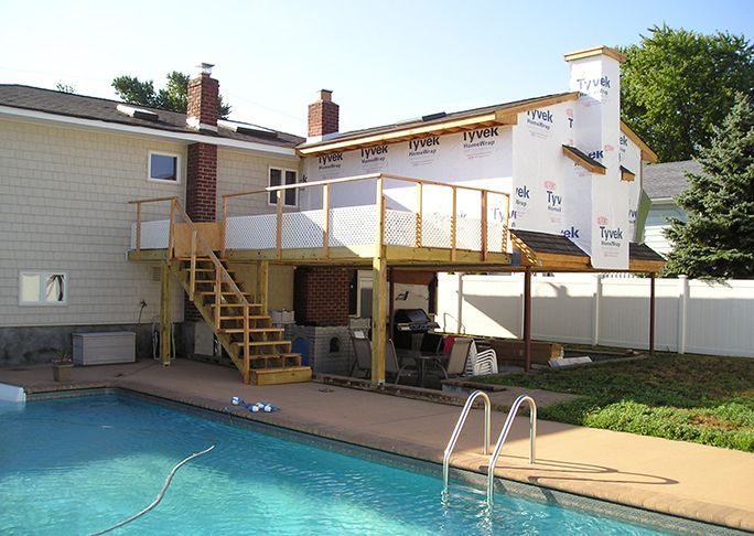 A house with a swimming pool in front of it