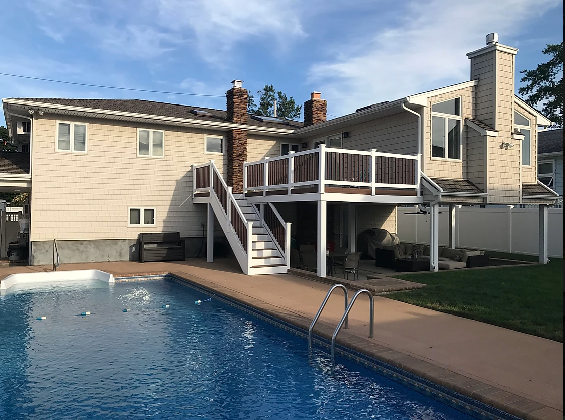 A large house with a swimming pool in front of it