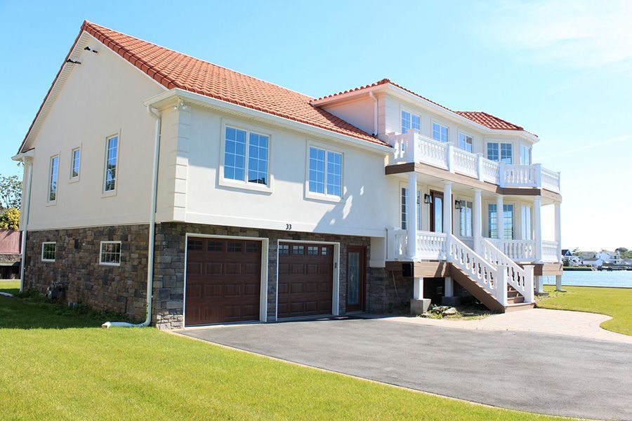 A large white house with a red tile roof