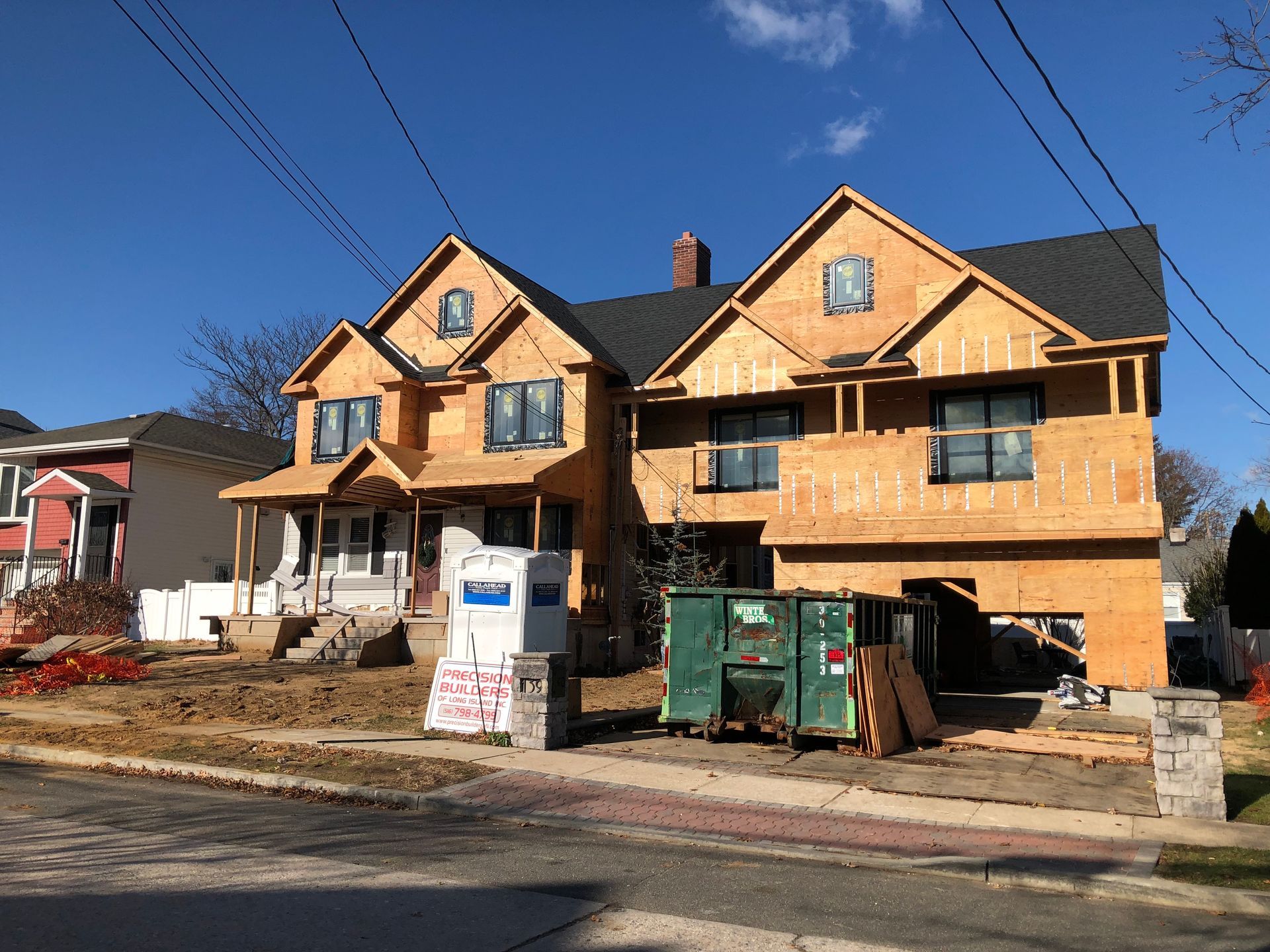 A large house is being built on the side of the road.