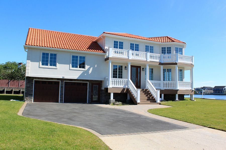 A large white house with a red tile roof