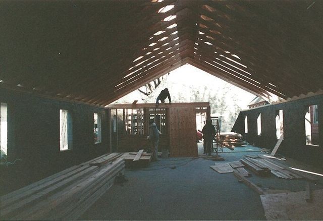 A black and white photo of a building under construction