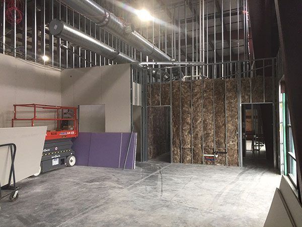 A large room with a lot of walls and a crane in it.