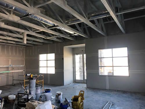 A room with a lot of windows and a ceiling that is being built.