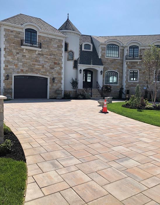 A large house with a large driveway and a large garage.