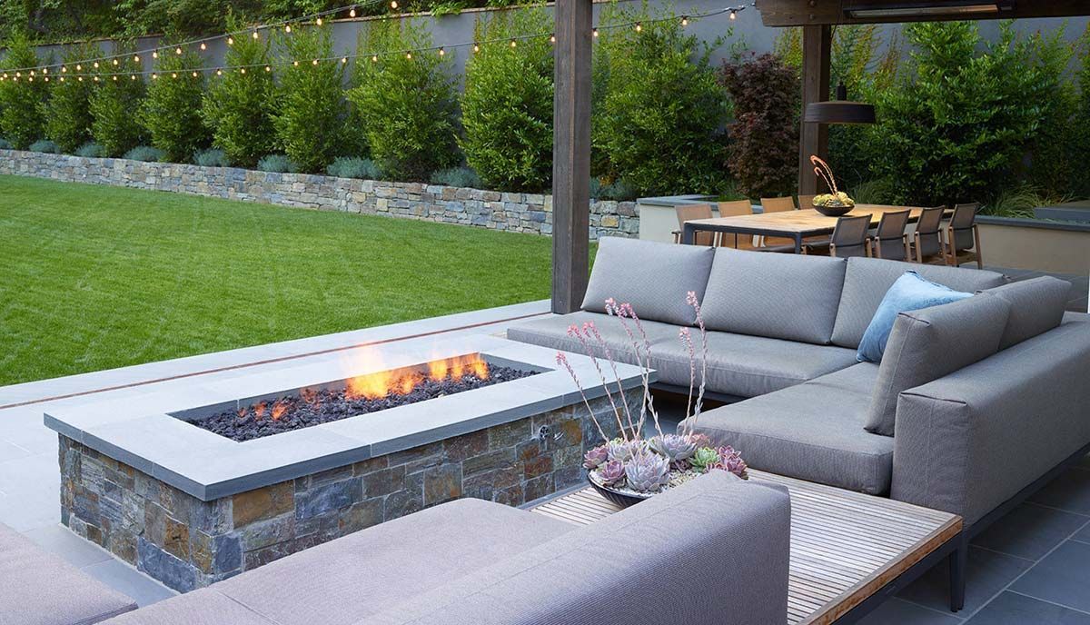 A patio with a fire pit and a couch