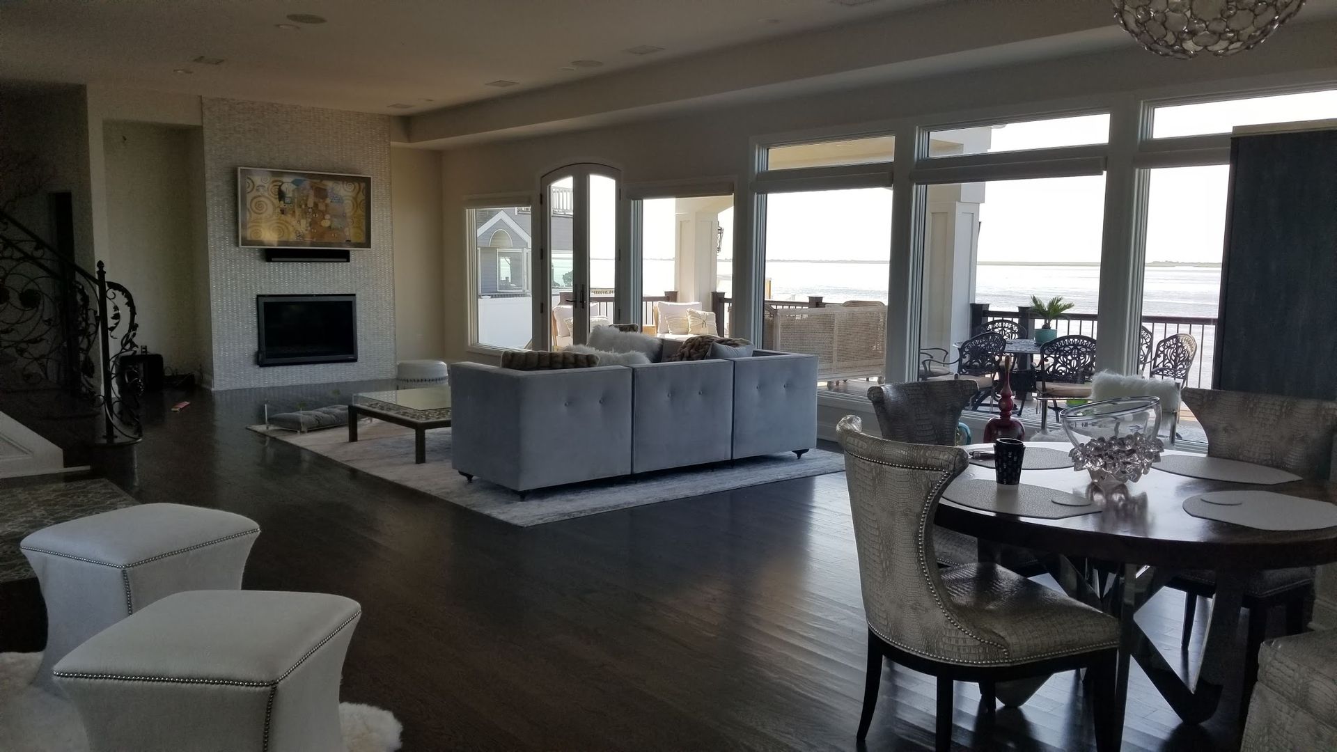 A living room with a couch , table , chairs and a fireplace.