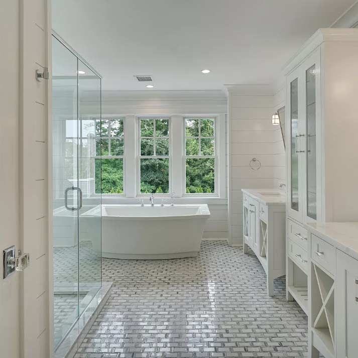 A bathroom with a bathtub and a walk in shower.
