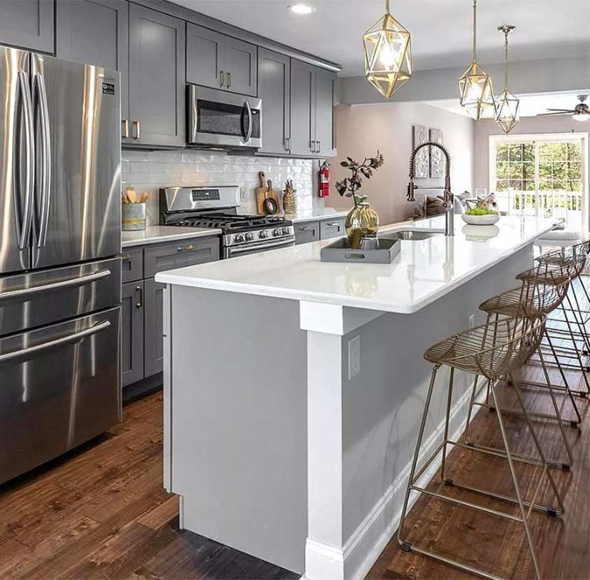 A kitchen with stainless steel appliances and a large island.