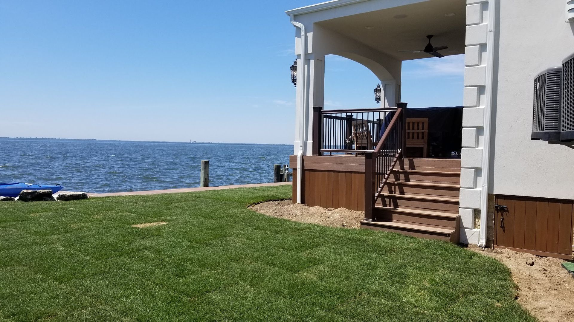 A house with a porch overlooking a body of water.