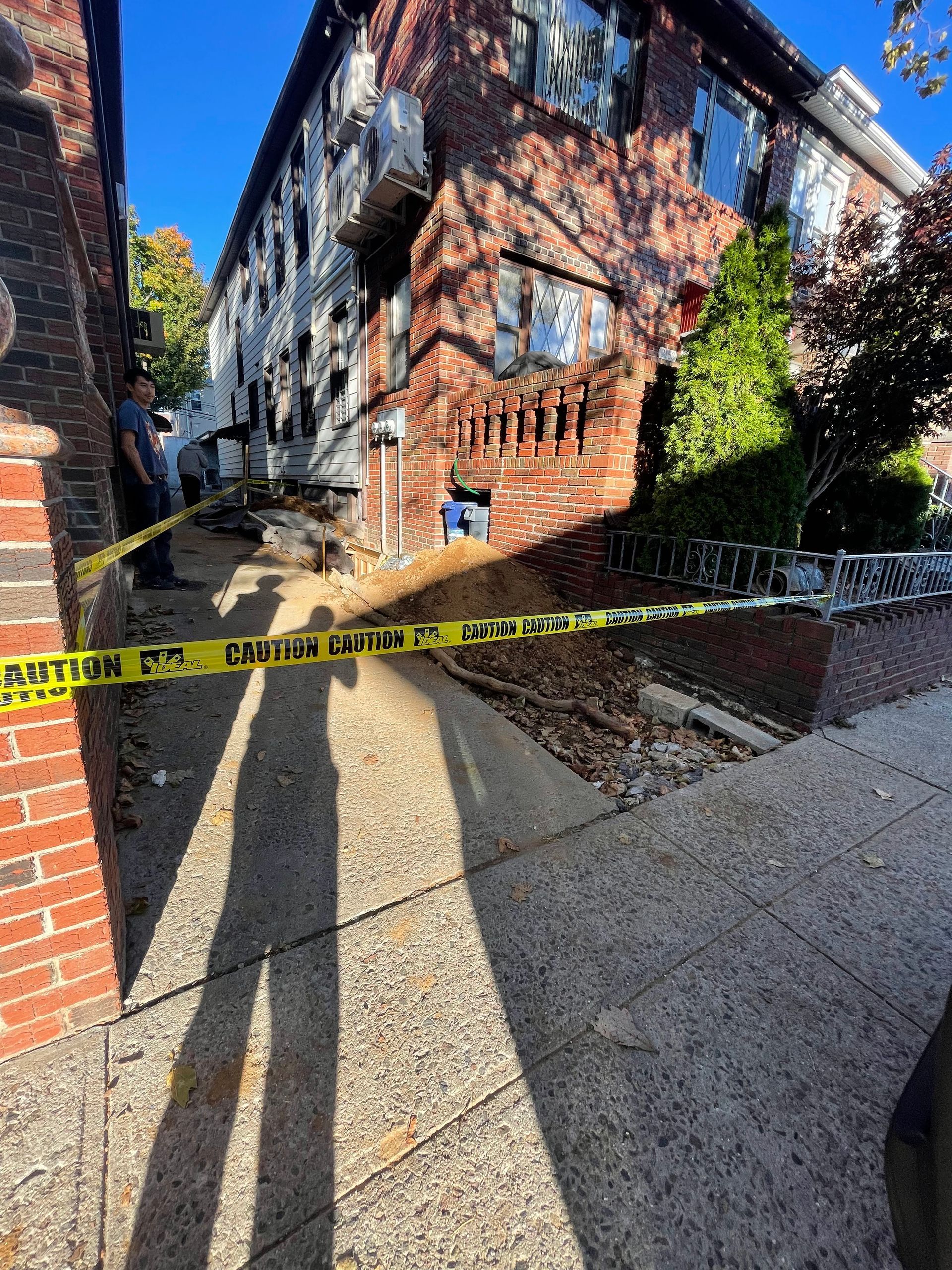 A brick building with a yellow caution tape around it.