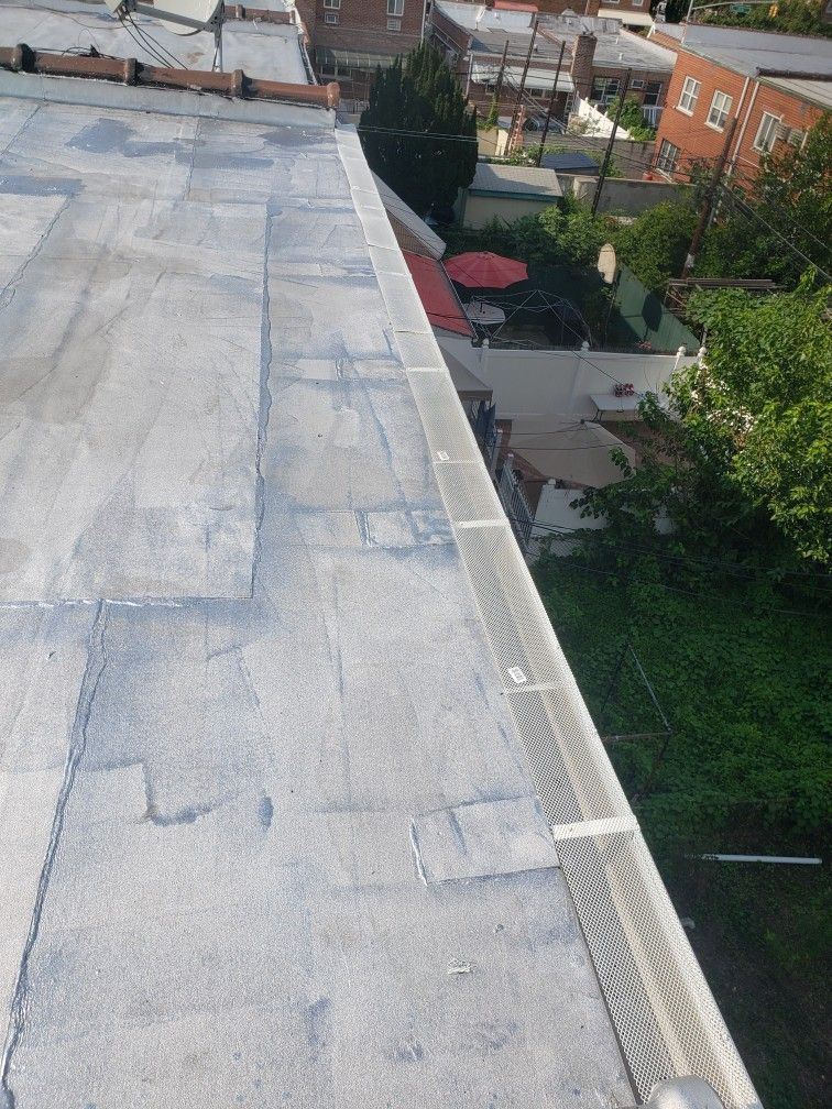An aerial view of a roof with a bird cage on it.