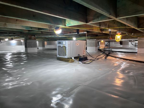 A humidifier is sitting in the corner of a flooded basement.