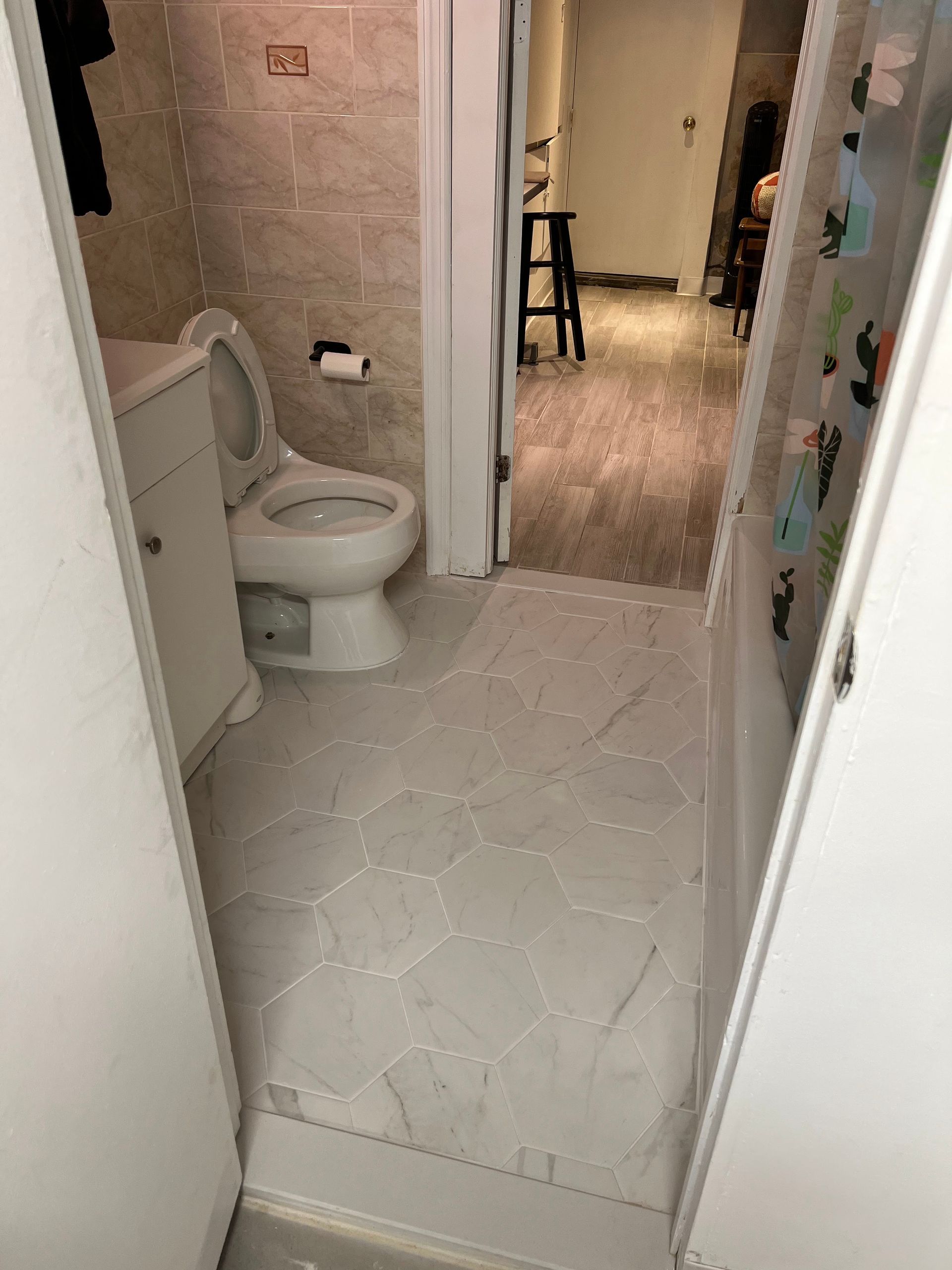 A bathroom with a toilet , sink , and door.