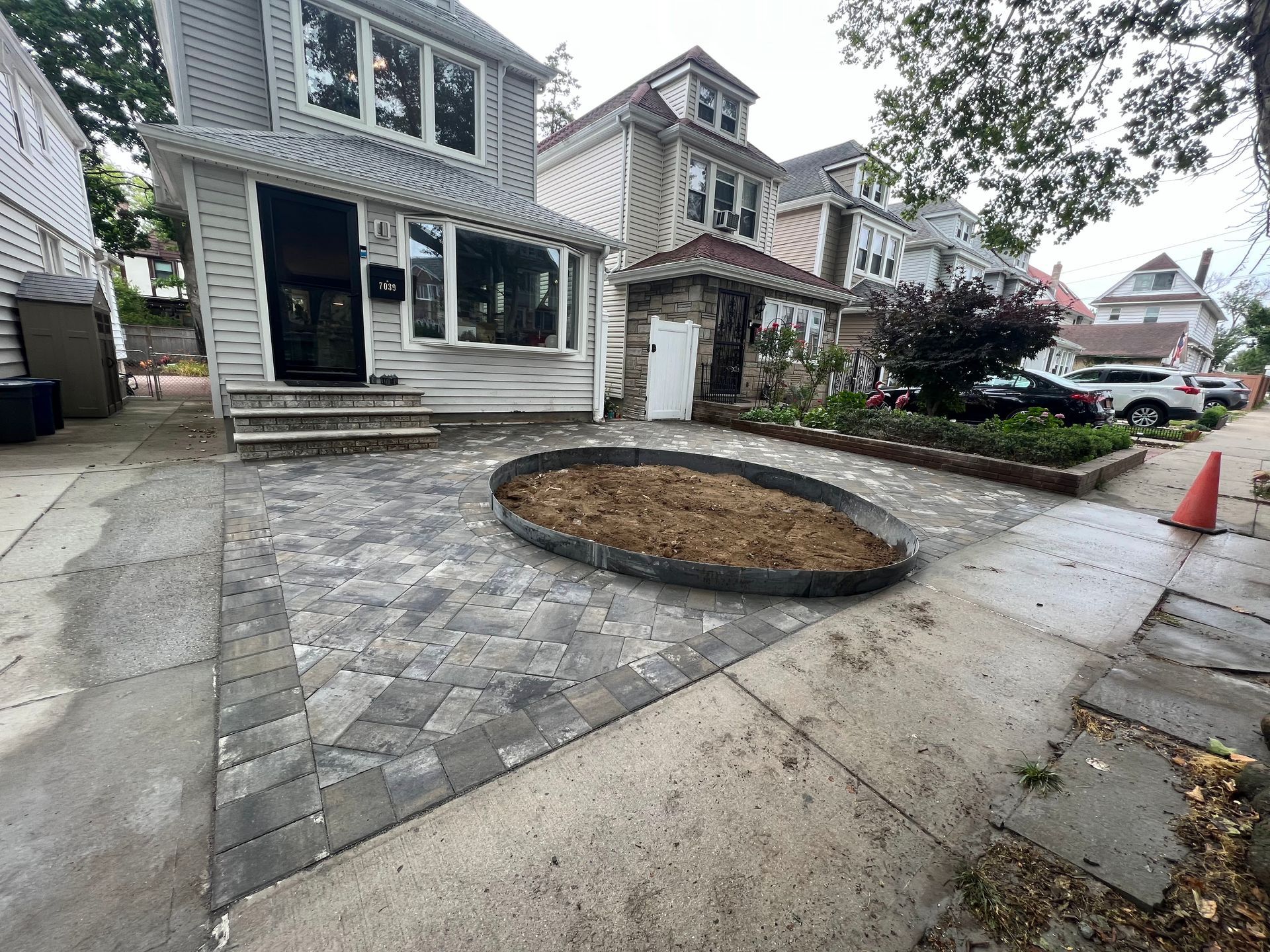 A large house with a circular driveway in front of it.