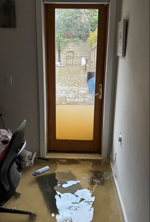 A flooded room with a door that is open