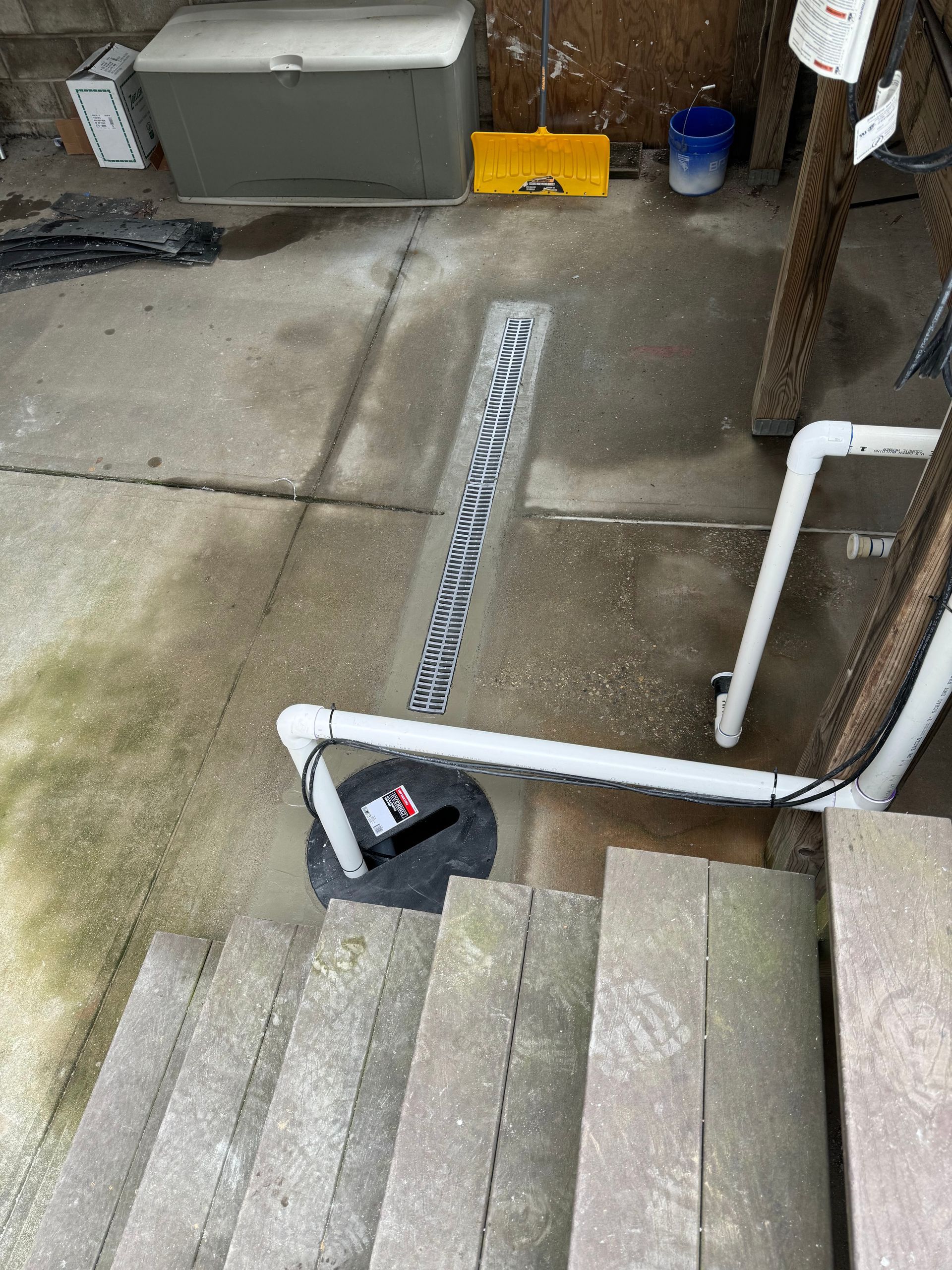 There is a drain on the side of the stairs.