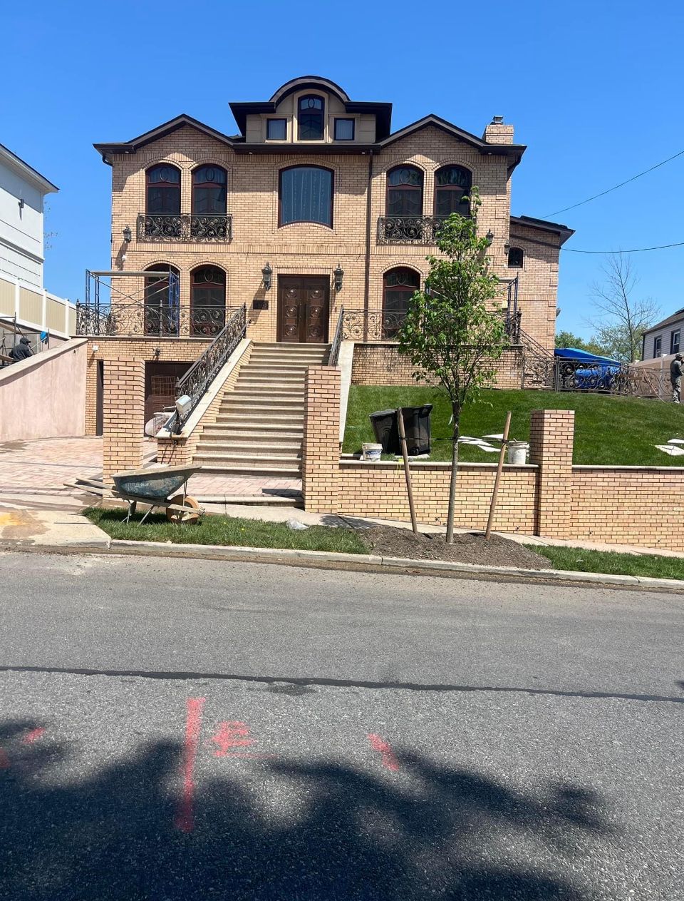 A large house with stairs leading up to it is being built on a hill.