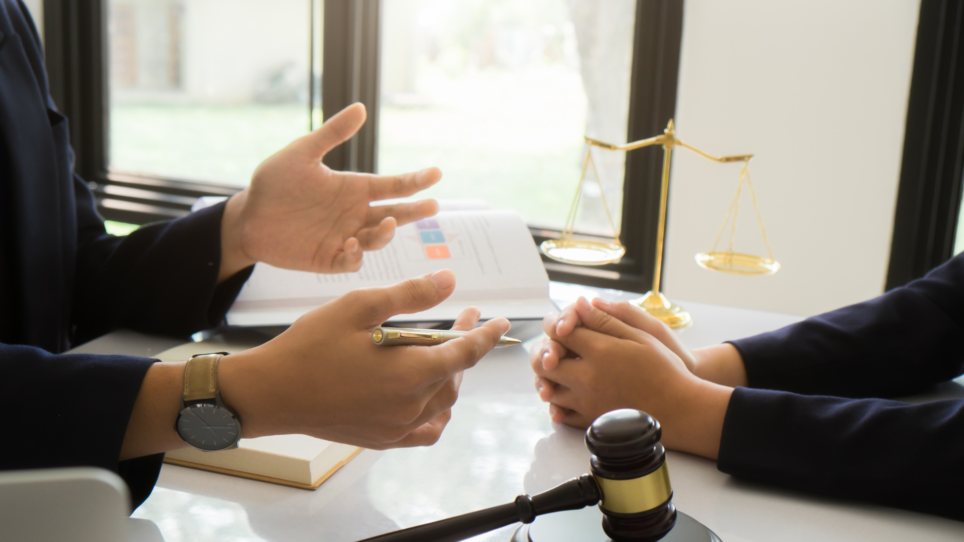 A man and a woman are sitting at a table talking to each other.