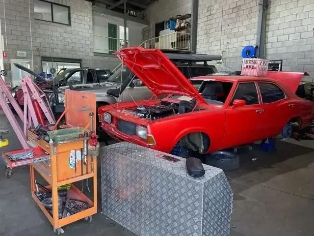 A Red Car With the Hood Up is in a Garage — BA Auto Electrical In West Mackay, QLD