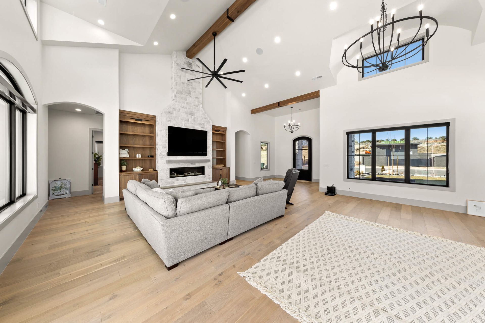 A living room with a couch , television , fireplace and rug.