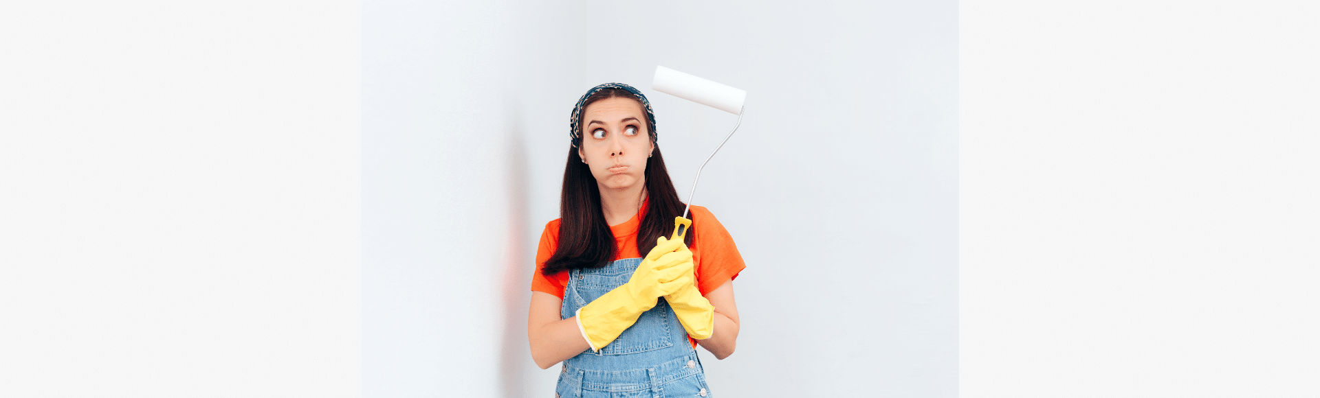 Woman looks stressed when doing her house painting