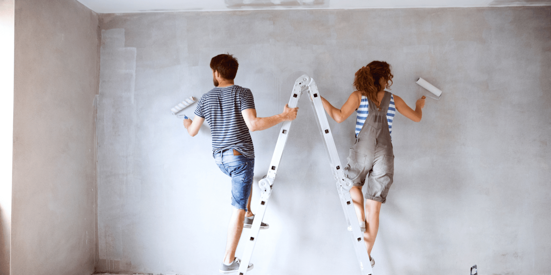 Young couple painting a wall