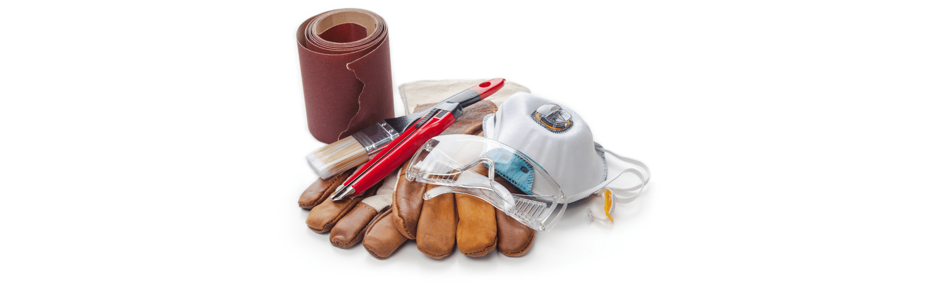 A pair of wooden gloves sitting on top of a pile of tools.