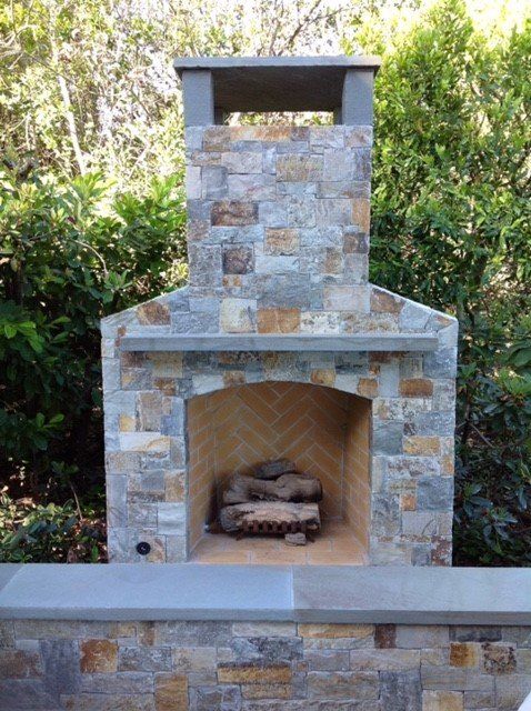 stone and brick outdoor fireplace