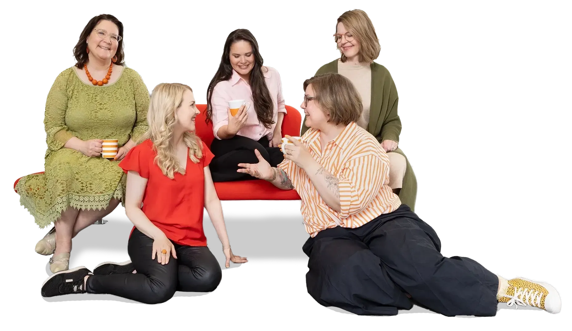 A group of women are sitting on a red couch talking to each other.