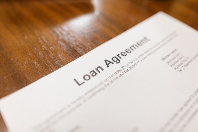 a loan agreement contract on a wooden desk