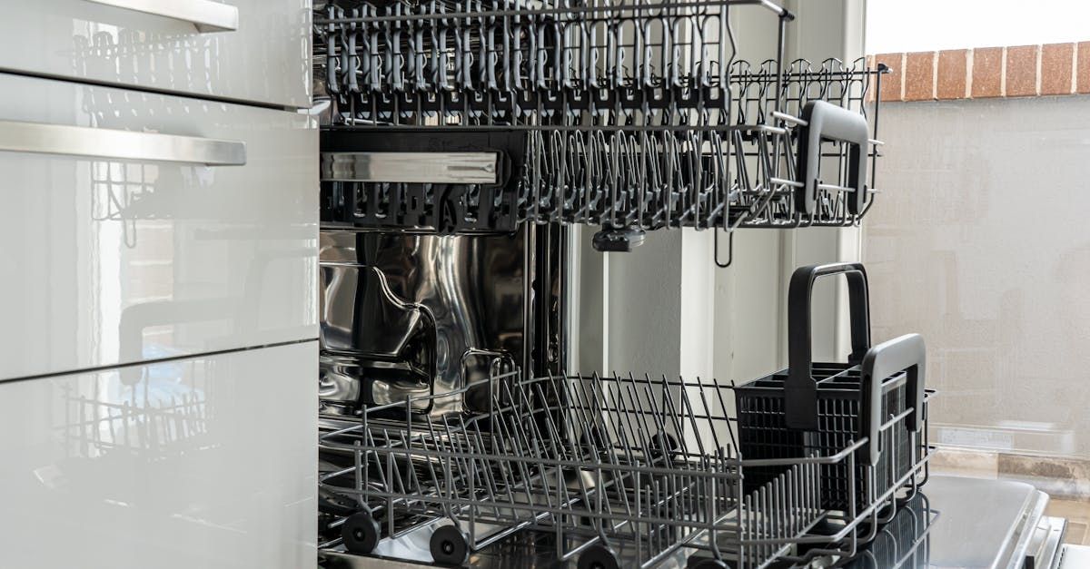 A dishwasher is filled with dishes and glasses in a kitchen.