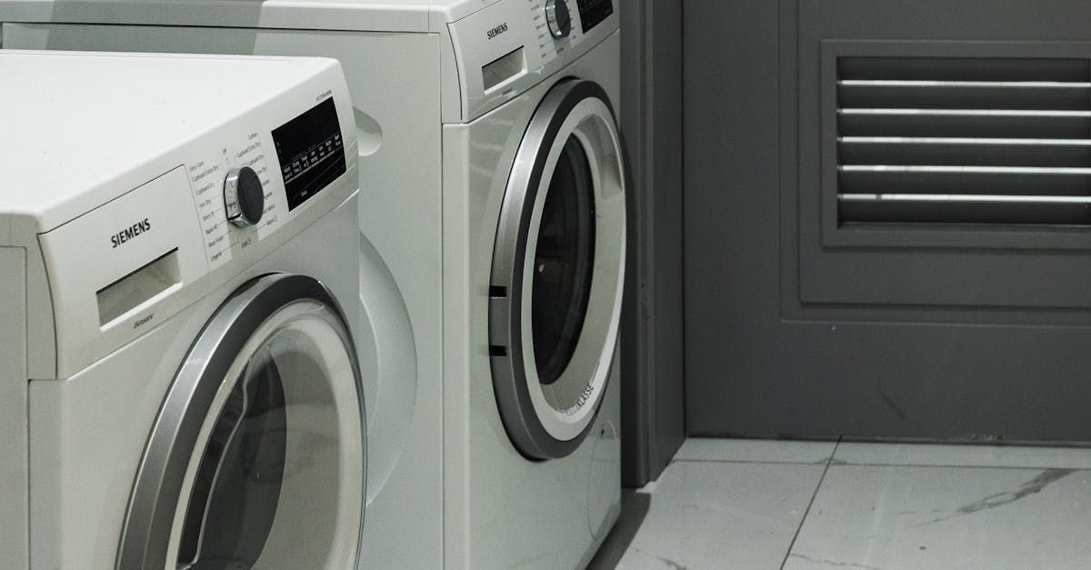 A washer and dryer are sitting next to each other in a laundry room.