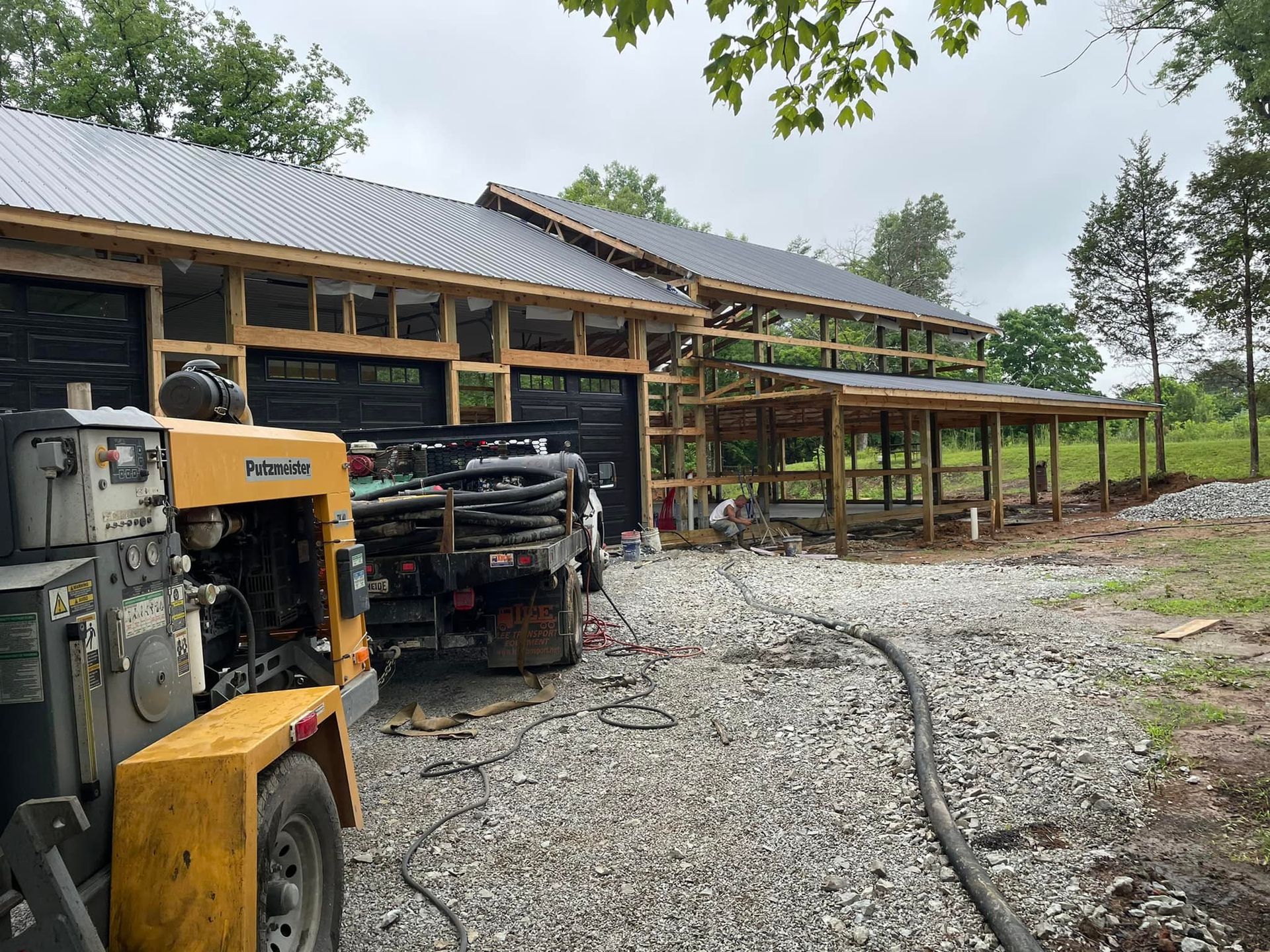 A truck is parked in front of a house under construction.