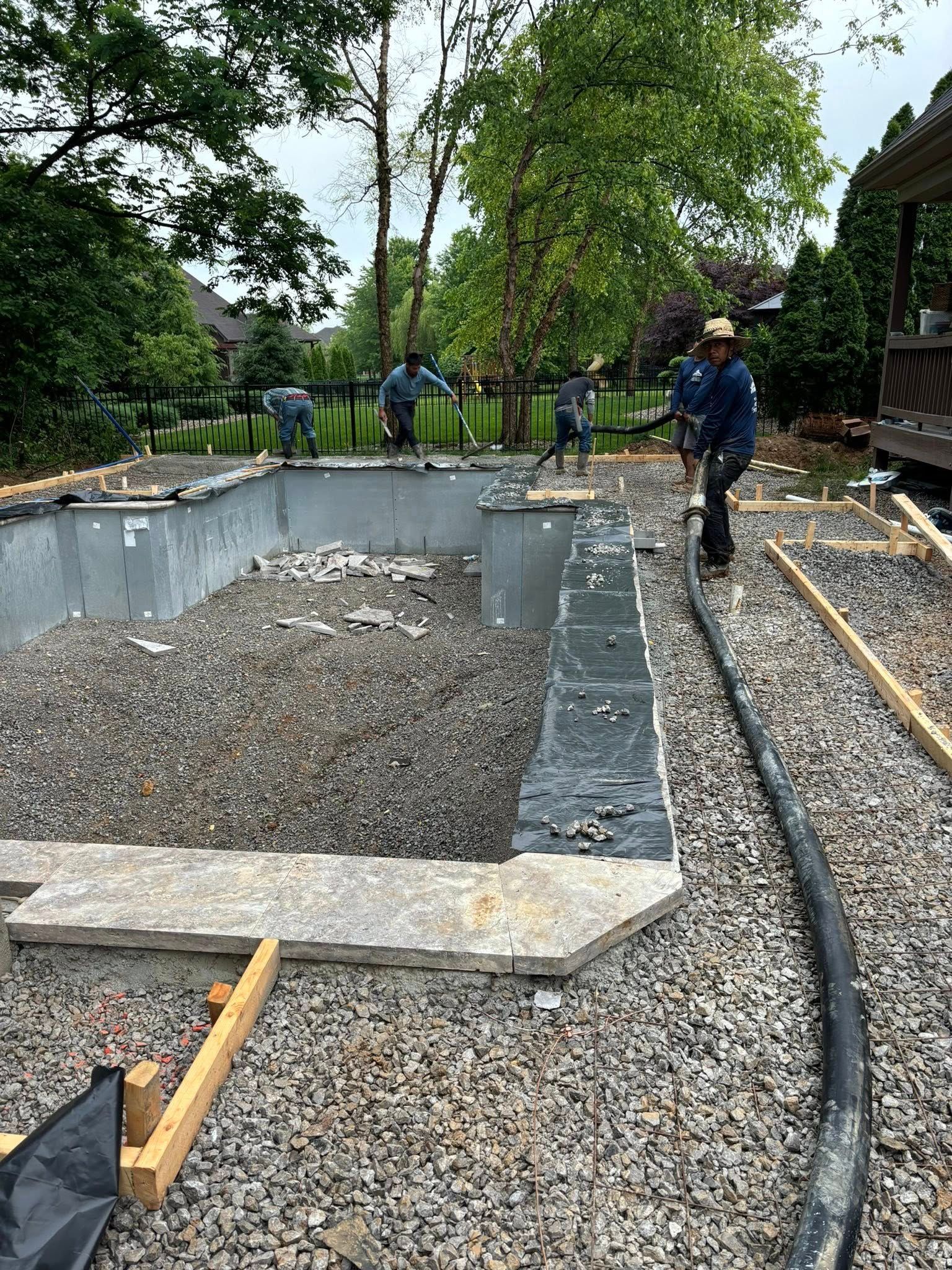 A group of people are working on a swimming pool.