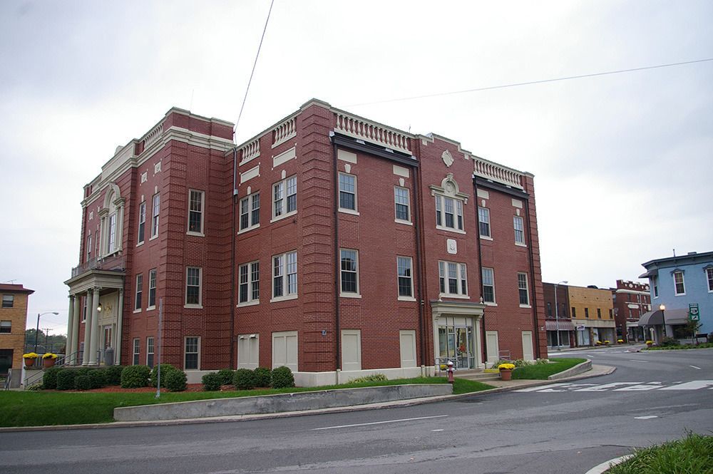 A large brick building sits on the corner of a street