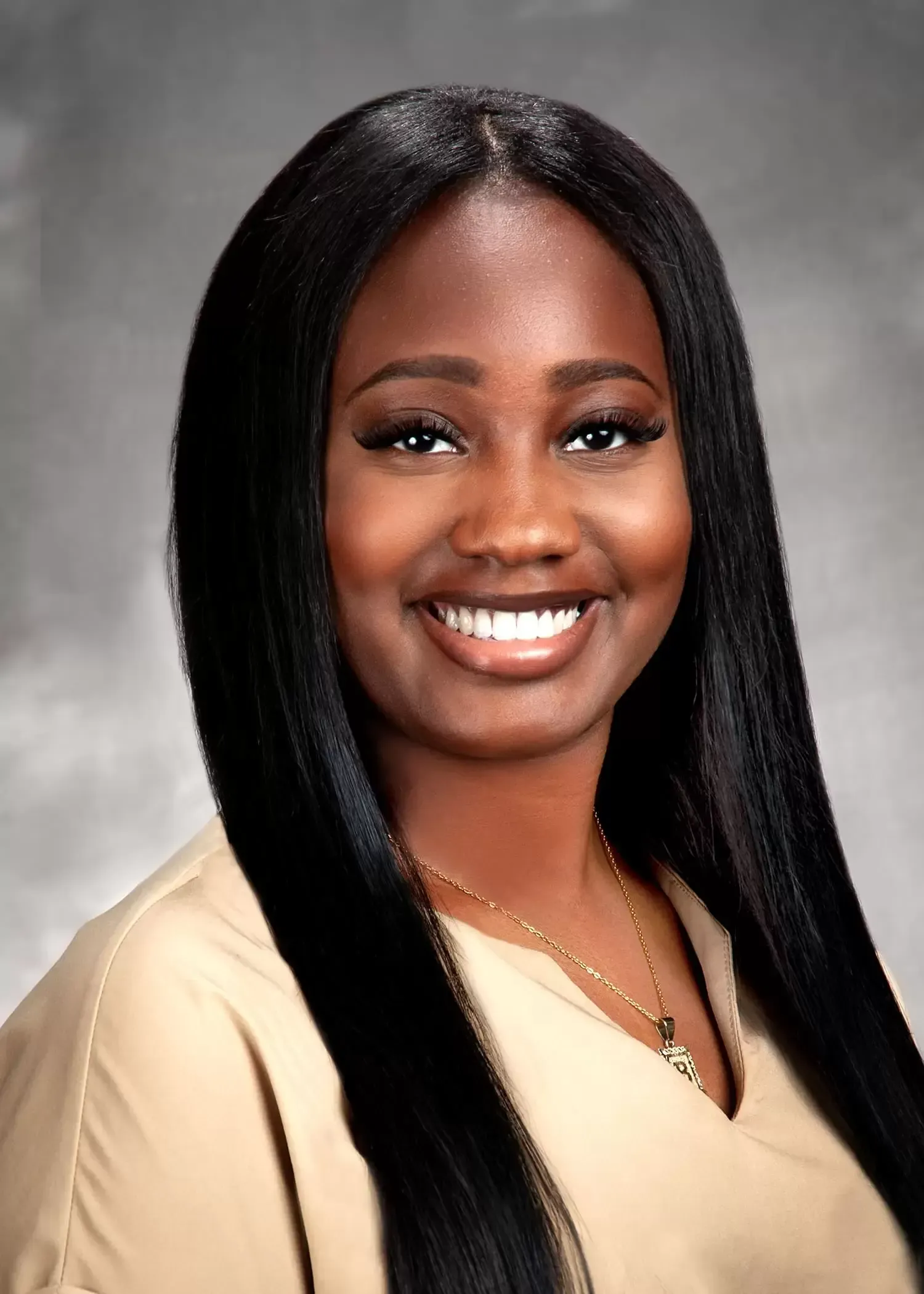 A woman with long black hair is smiling for the camera