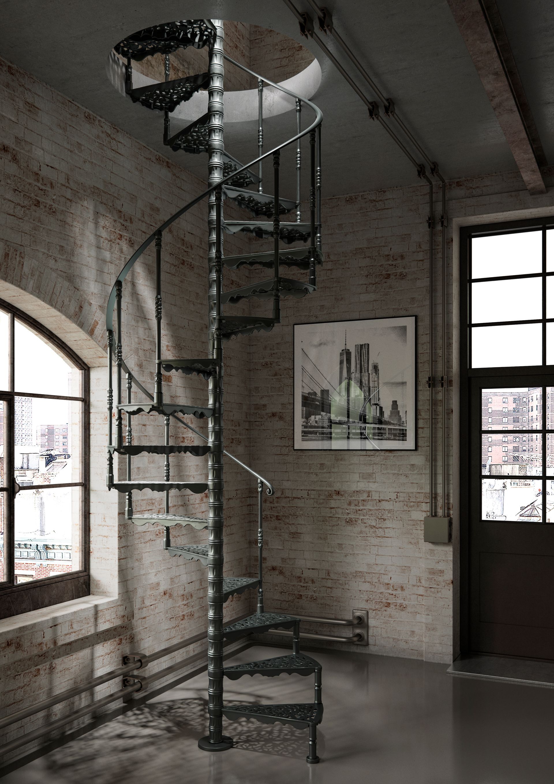 Scala a chiocciola in un loft in mattoni con ampie finestre e una stampa incorniciata alla parete.